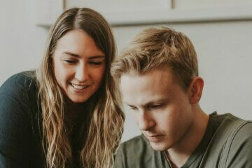 Two people looking at a website